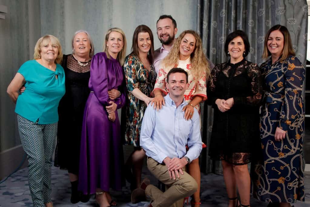 Group of friends enjoying a fun photo session at a studio booth in Ireland.
