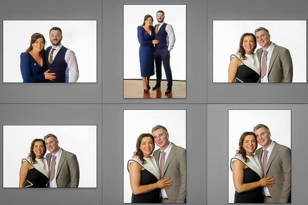 Group of professionally dressed people posing for photos at studio booth.