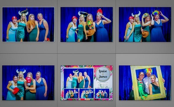 Group of women in fun costumes with props at studio booth event.