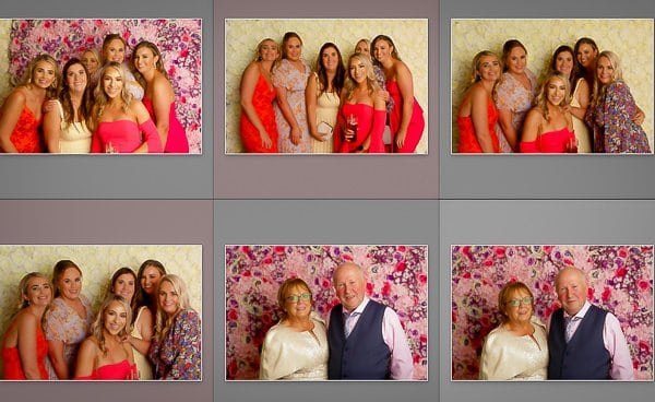 Group of women and a couple posing at a photo booth event.