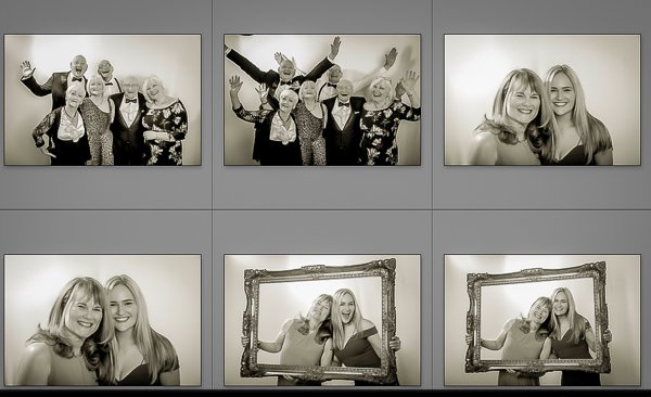 Group of people enjoying photo booth pictures at an event.